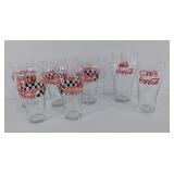 Coca-Cola glasses, six are 6" tall, one is 7"