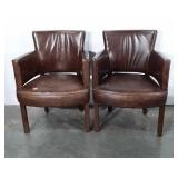 Two leather chairs, both show wear