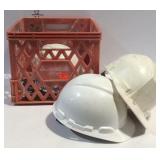 Plastic crate with three hard hats