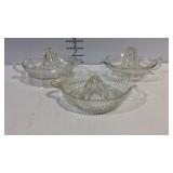 Three glass citrus juicers