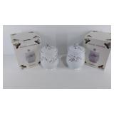 Two ceramic canisters with lids, both with