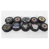 Eleven hockey pucks