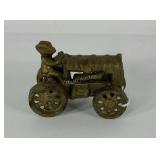 Cast iron man on tractor, 3 1/2