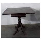 Mahogany game table with brass feet, table shows