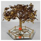 Metal apple tree sculpture on mirrored tray,
