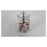 Ball jar filled with dice, some are souvenirs