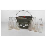 Milk bottles in painted galvanized bucket,