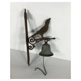Cast iron bird bell hanger with bell, shows rust