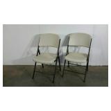 Two Lifetime molded plastic folding chairs