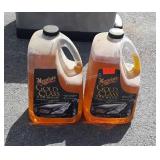 Full jug and partial jug of gold glass car wash