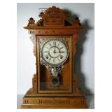 Key wound pendulum clock in carved wood case.