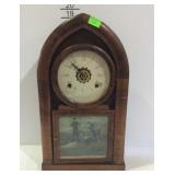 Key wound shelf clock with cased arched design,