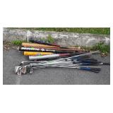 Group of golf clubs and baseball bats