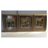 Three framed pictures of city scenes
