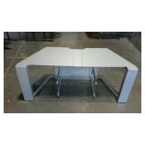 Television stand with 2 lower glass shelves.