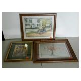 Group of three framed home decor prints.