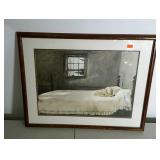 Framed and matted print of dog on bed. 32"×26".