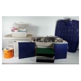 Storage totes with office supplies, cords, VHS