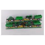 Six toy tractors pulling a farm cart, all new in
