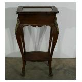 Ornate side table with hinged glass top, claw