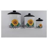 Three ceramic canisters with lids, tallest