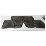 Four rubber car floor mats, shows wear