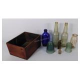 Group of glass bottles, a glass lighter,