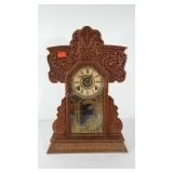 Gingerbread parlor clock with key and pendulum,