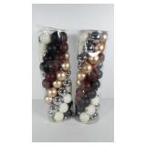 Holiday decor, two tubes of Christmas ornaments