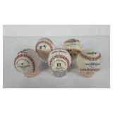 Five baseballs, most have signatures, signatures