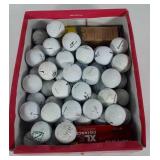 Shoe box full of used golf balls, includes
