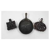 Cast iron skillet with chip and two trivets