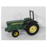 Metal John Deere tractor toy, 7" × 4" × 5"