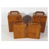 Set of four wooden canisters with lids and