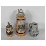 Two German steins with lids, one with crack, and