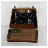 Singer sewing machine with accessories and case,