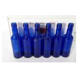 Eighteen cobalt blue glass bottles, 7.5"