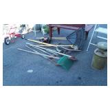 Group of long handle tools, rakes, clippers, limb