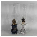 Two oil lamps, one with floral painted base,