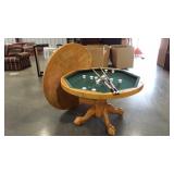 Three in one game table with two pool cues and