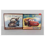 Two Disney cars characters metal signs, each