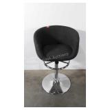 Grey upholstered adjustable bar stool with barrel