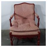 Red wooden arm chair with striped upholstery