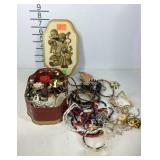 Tin of costume jewelry
