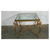 Glass topped table with heavy weight metal base,