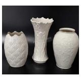 Three Lenox vases, two gold-rimmed, 7" to 9" tall