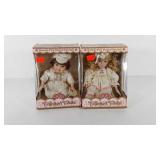 Two porcelain dolls, boy and girl, still in boxes