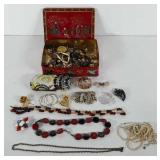 Metal tin full of jewelry, includes necklaces,