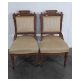 Two upholstered parlor chairs on wheels,