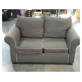 Loveseat. Rolled arm. Grey with lighter piping.